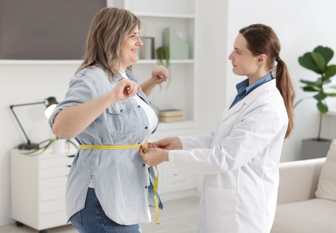 Doctor measuring a patient's progress in clinic