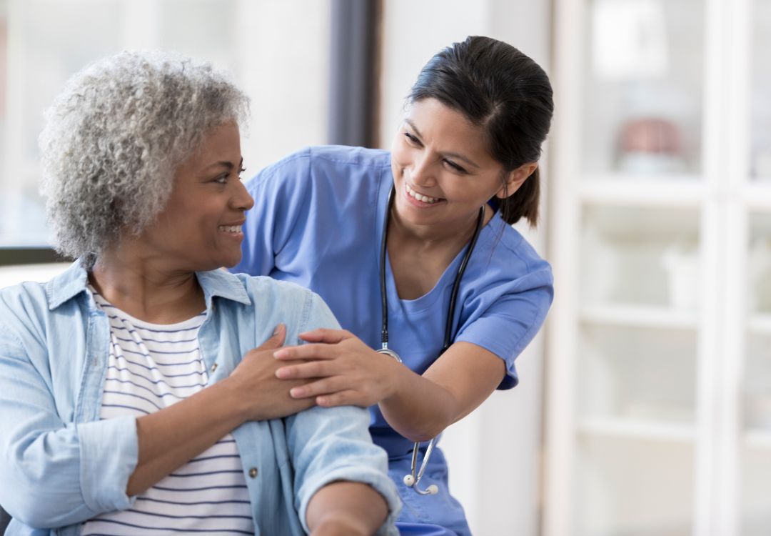 Nurse caring for a smiling patient during an IV visit